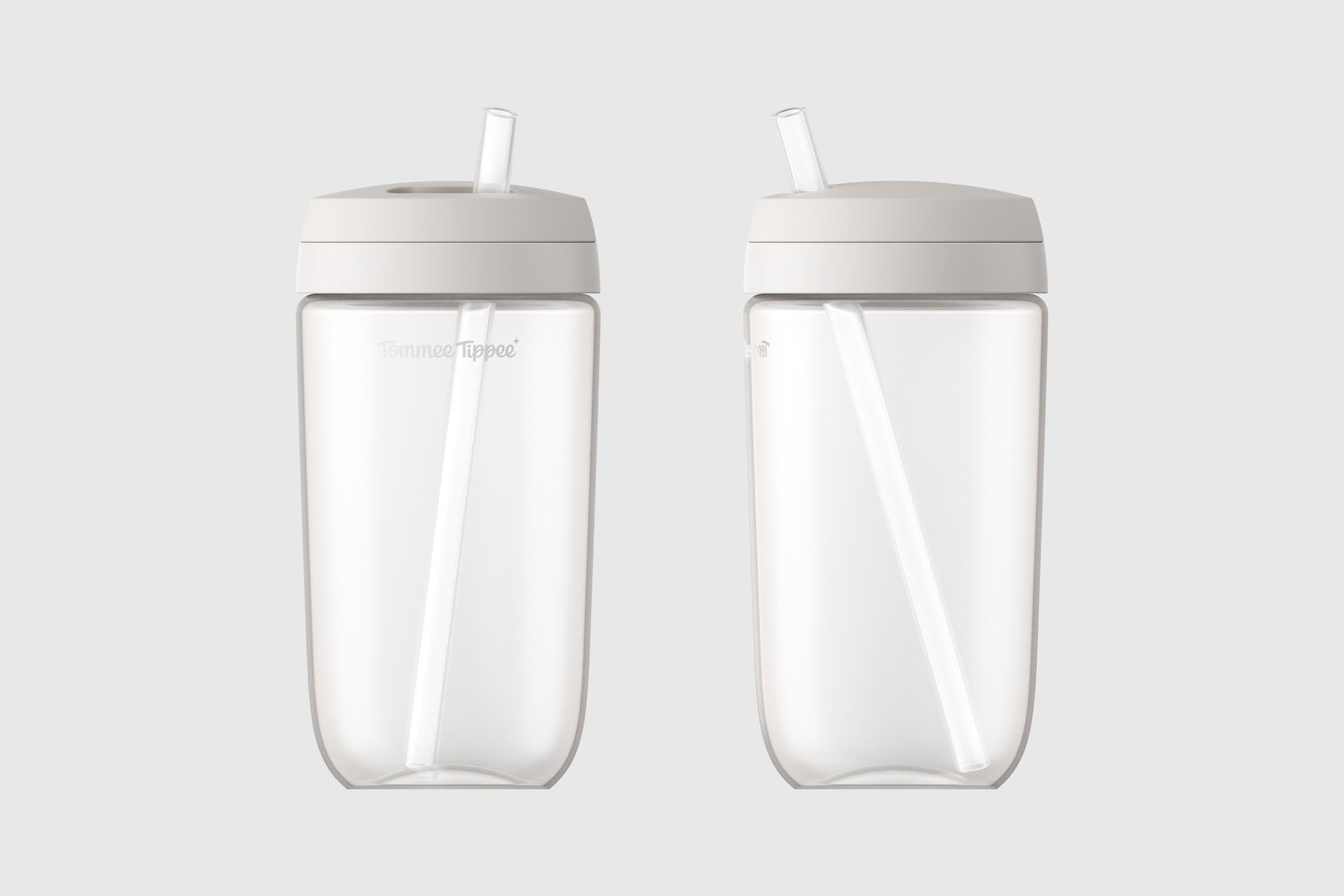 Front view of two tall white baby bottles side by side
