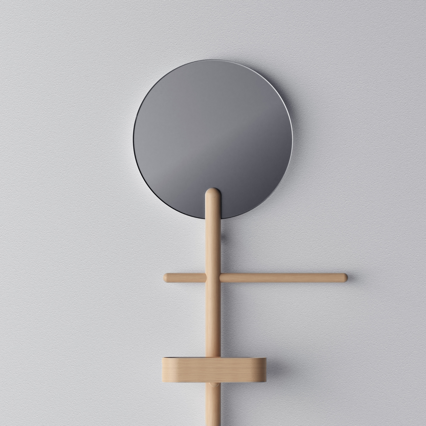 Circular mirror mounted on a wooden wall-hanging rack with accessory pegs