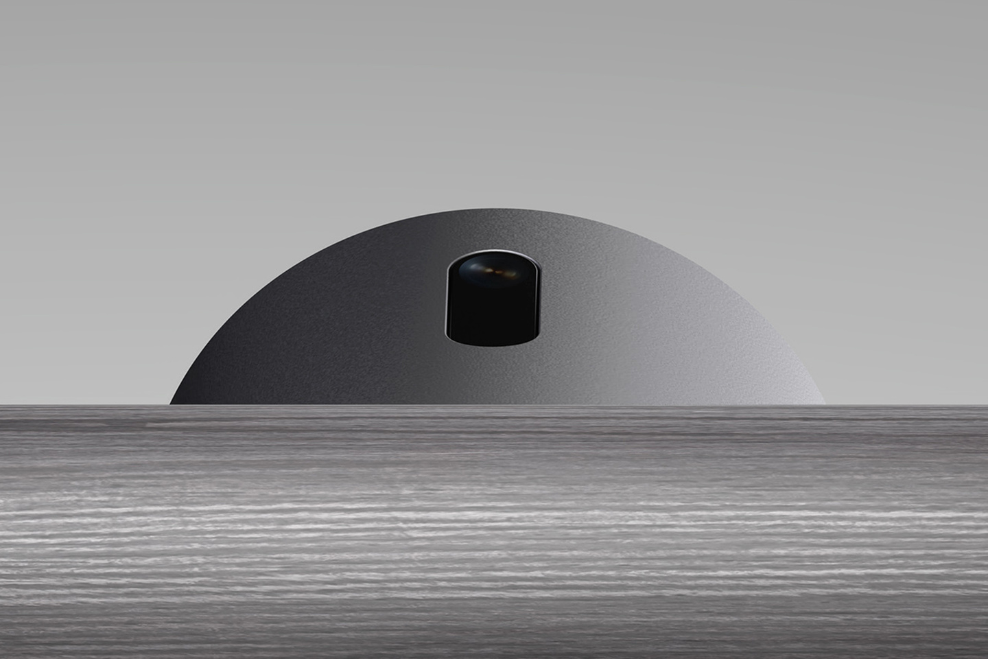 Side view of a black cylindrical device component on a light background