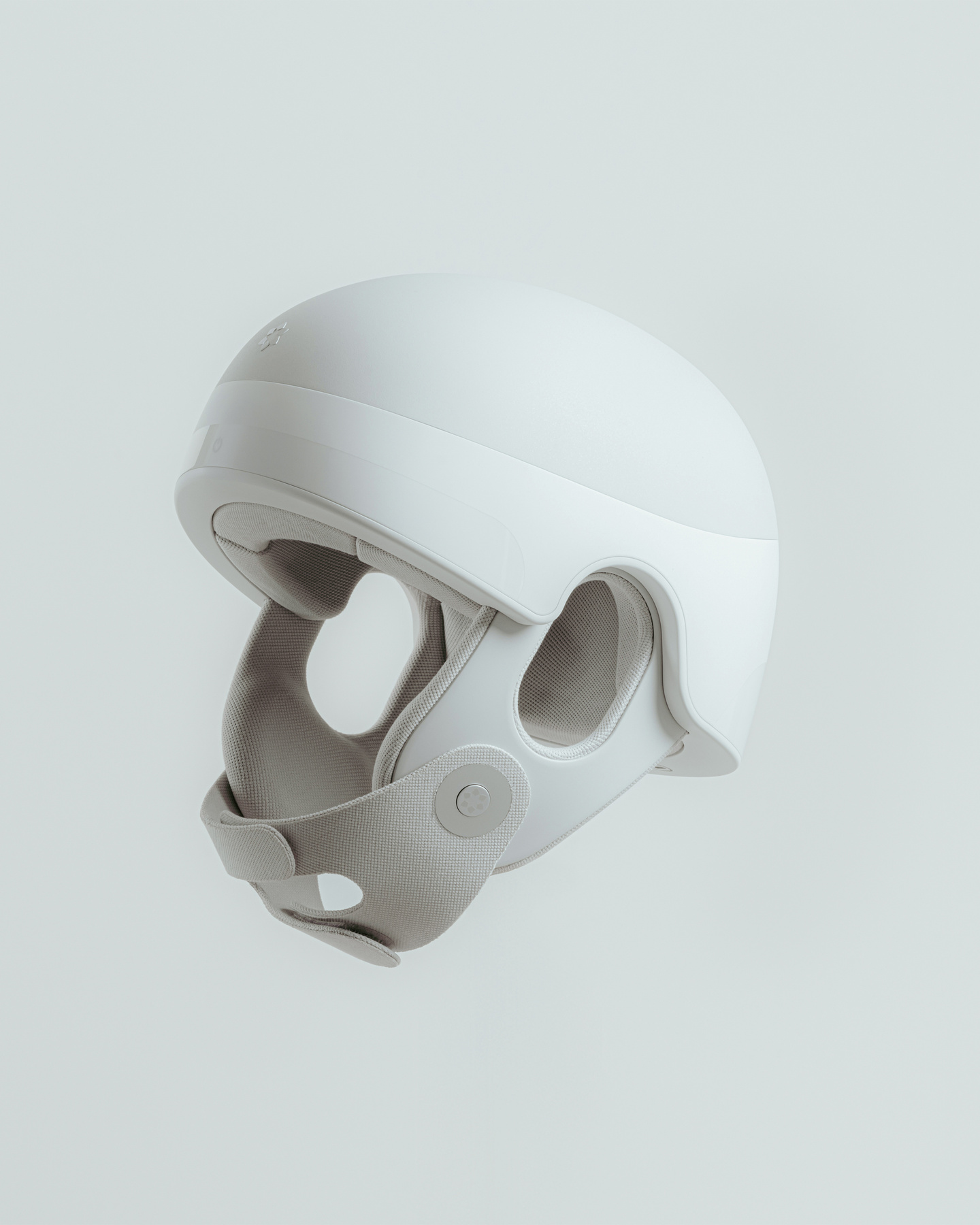 White wearable medical head device studio render against a light grey background