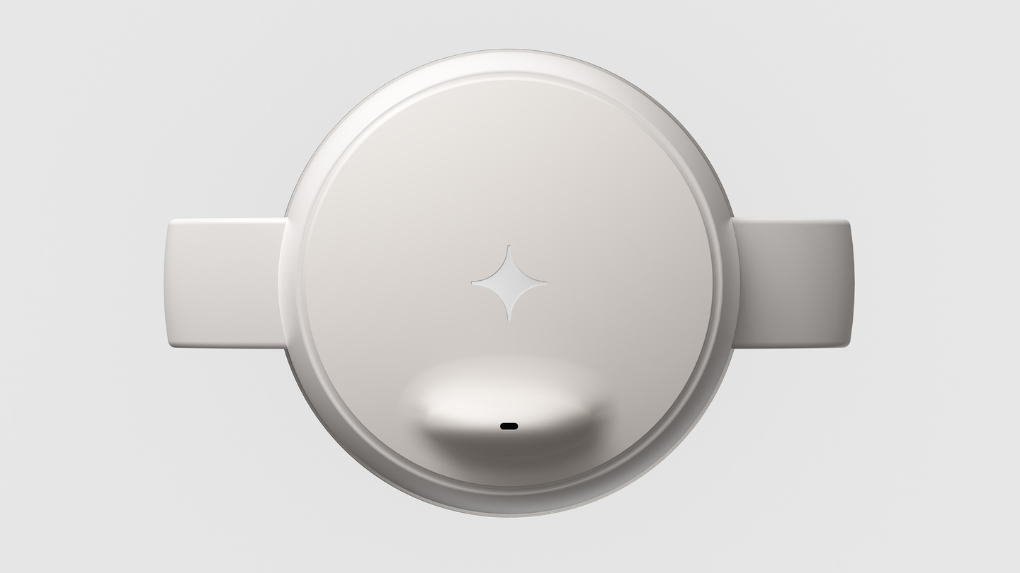 Overhead top-down view of a white sippy cup lid and handles