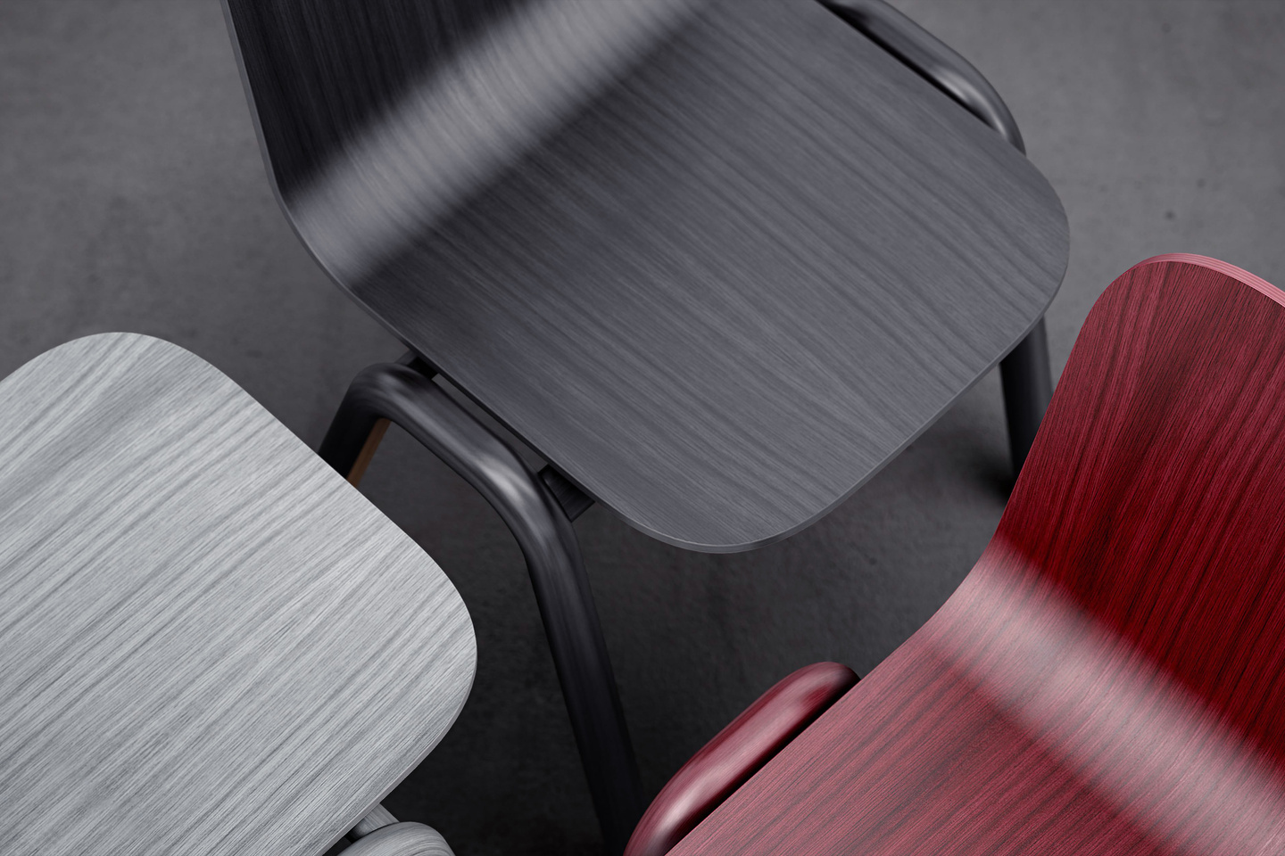 Close-up view of wooden chair backrests showing grey, black, and reddish wood grain finishes