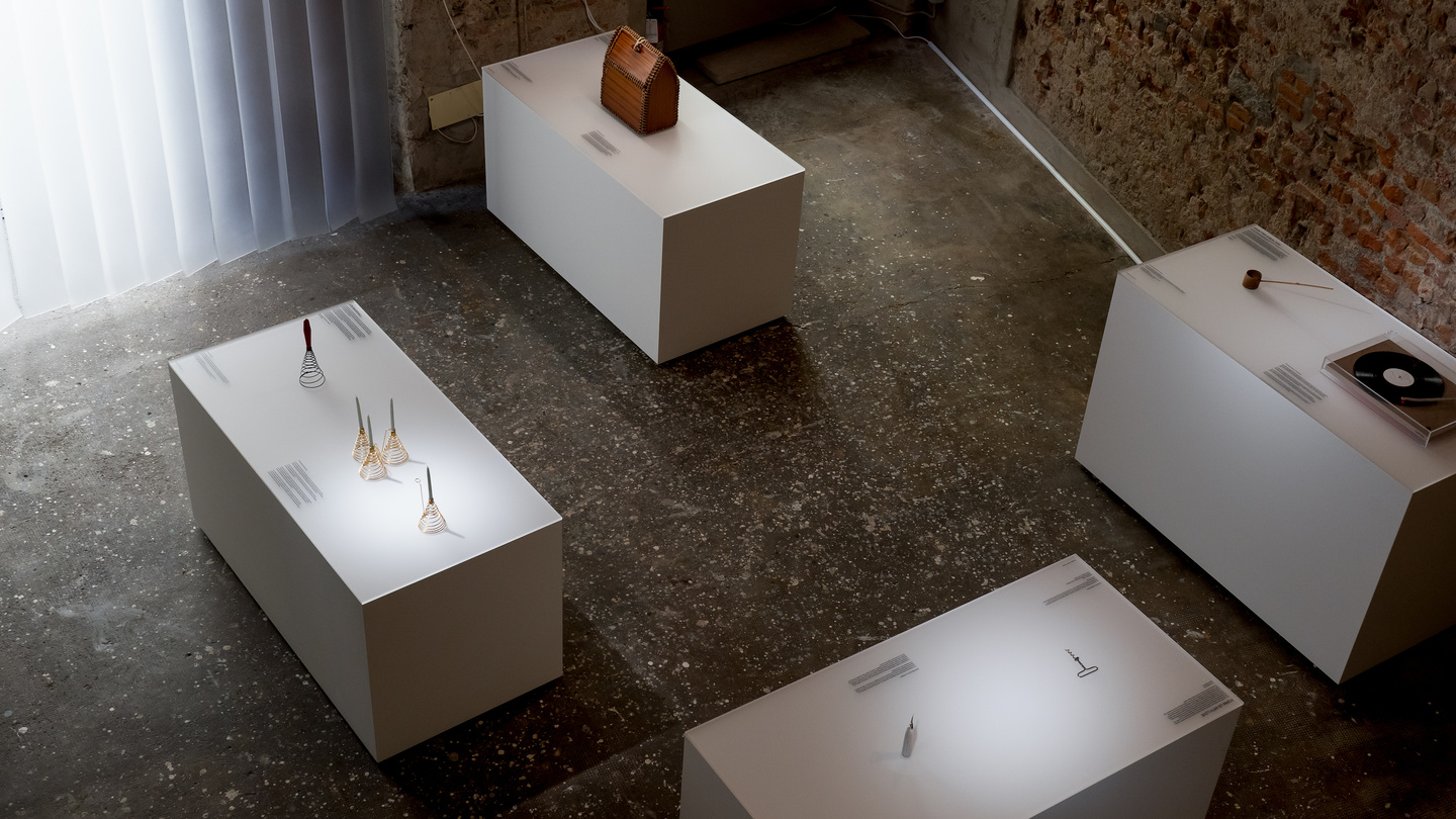 Overhead view of white rectangular display pedestals on stone floor