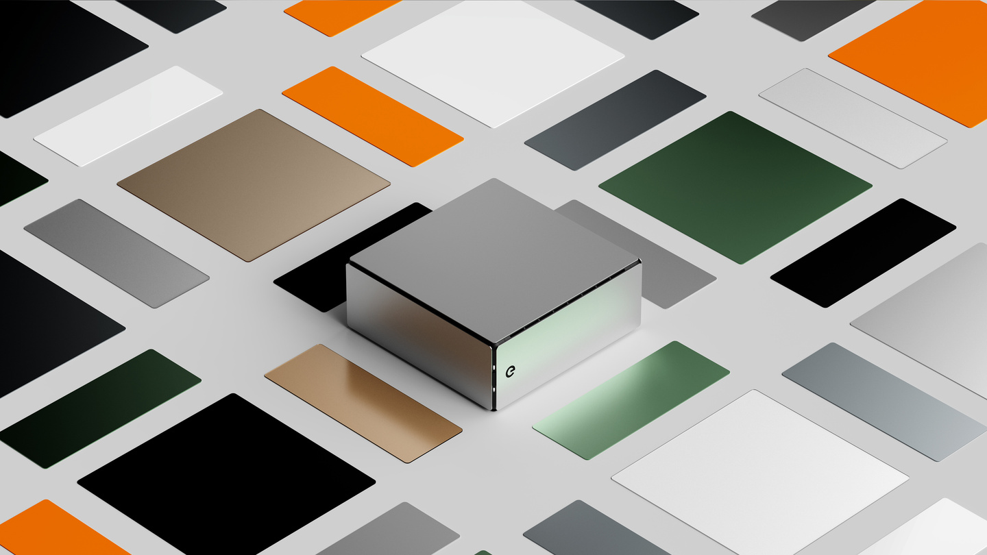 Top-down studio shot of square hardware modules arranged on colorful grid pattern