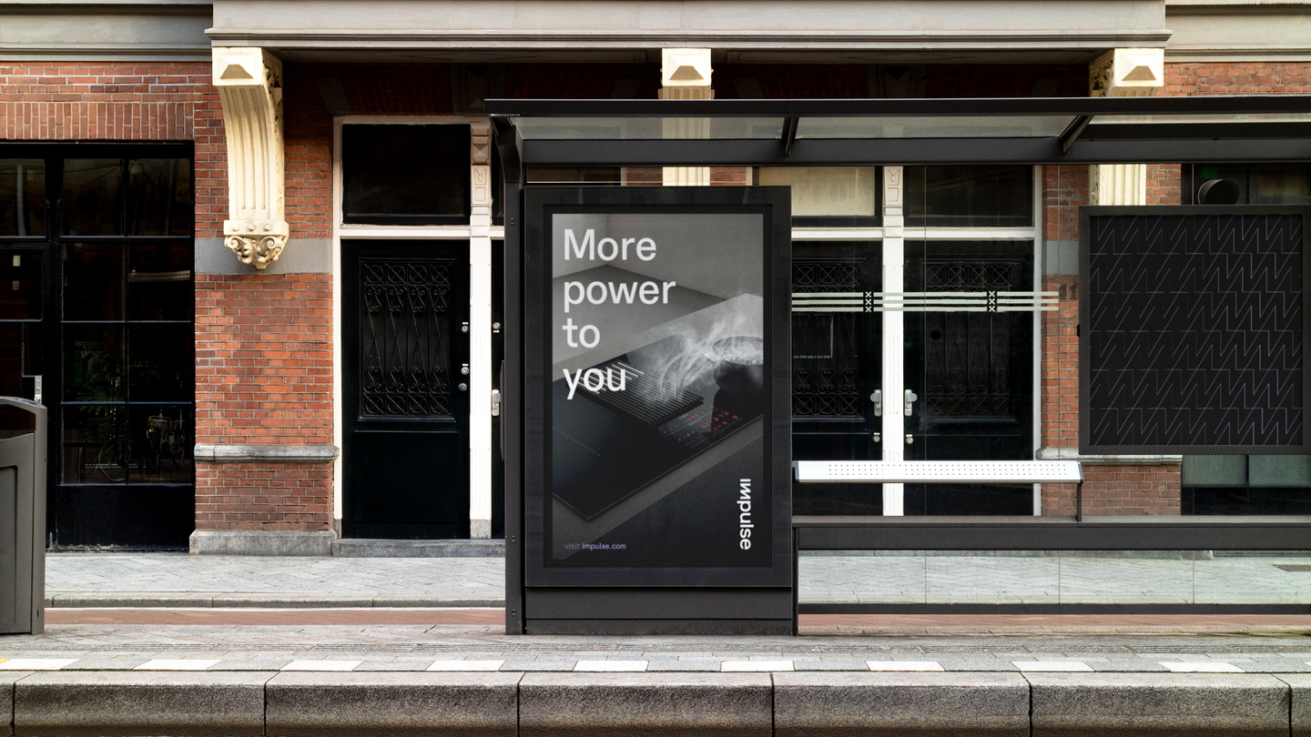 Outdoor bus stop shelter displaying an Impulse advertisement poster
