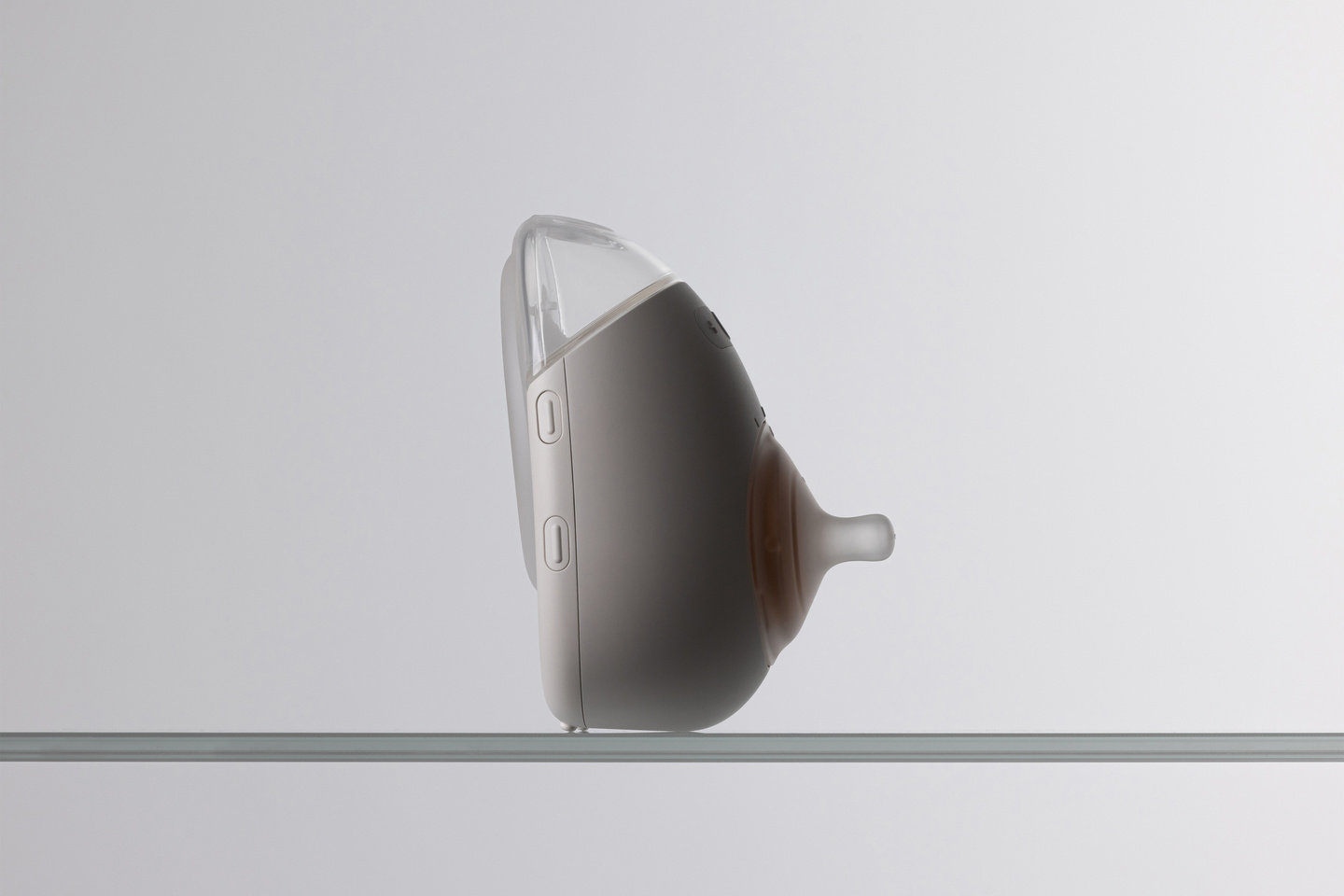 Studio shot of the white Avira breast pump unit standing on a surface.