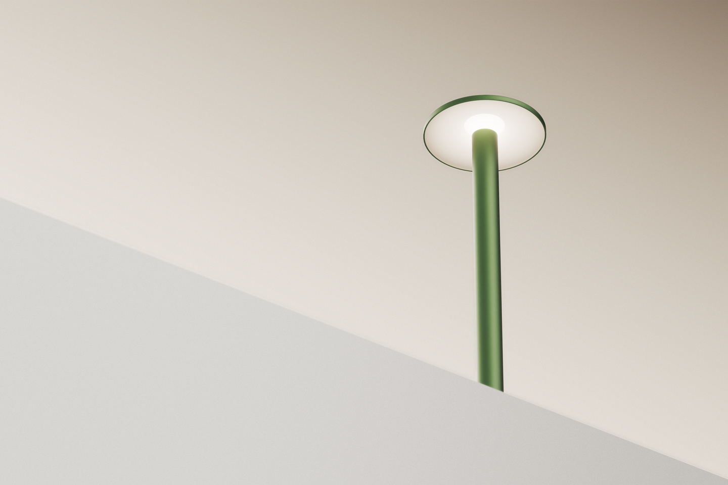 Illuminated green Parasol Lamp casting light downward against a light wall.