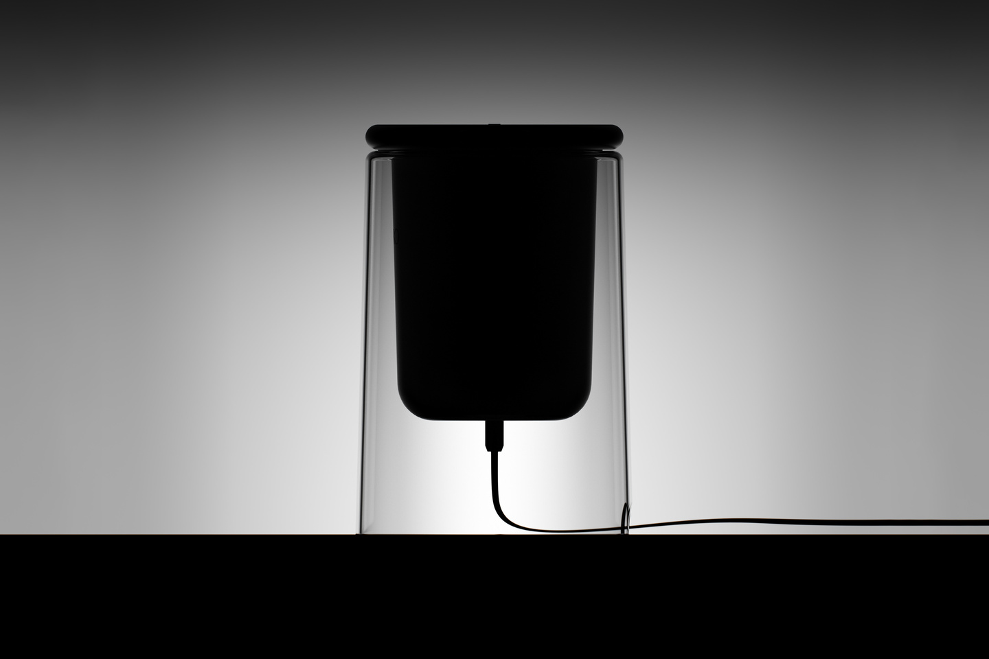 Black silhouette of electric diffuser unit against a light back wall
