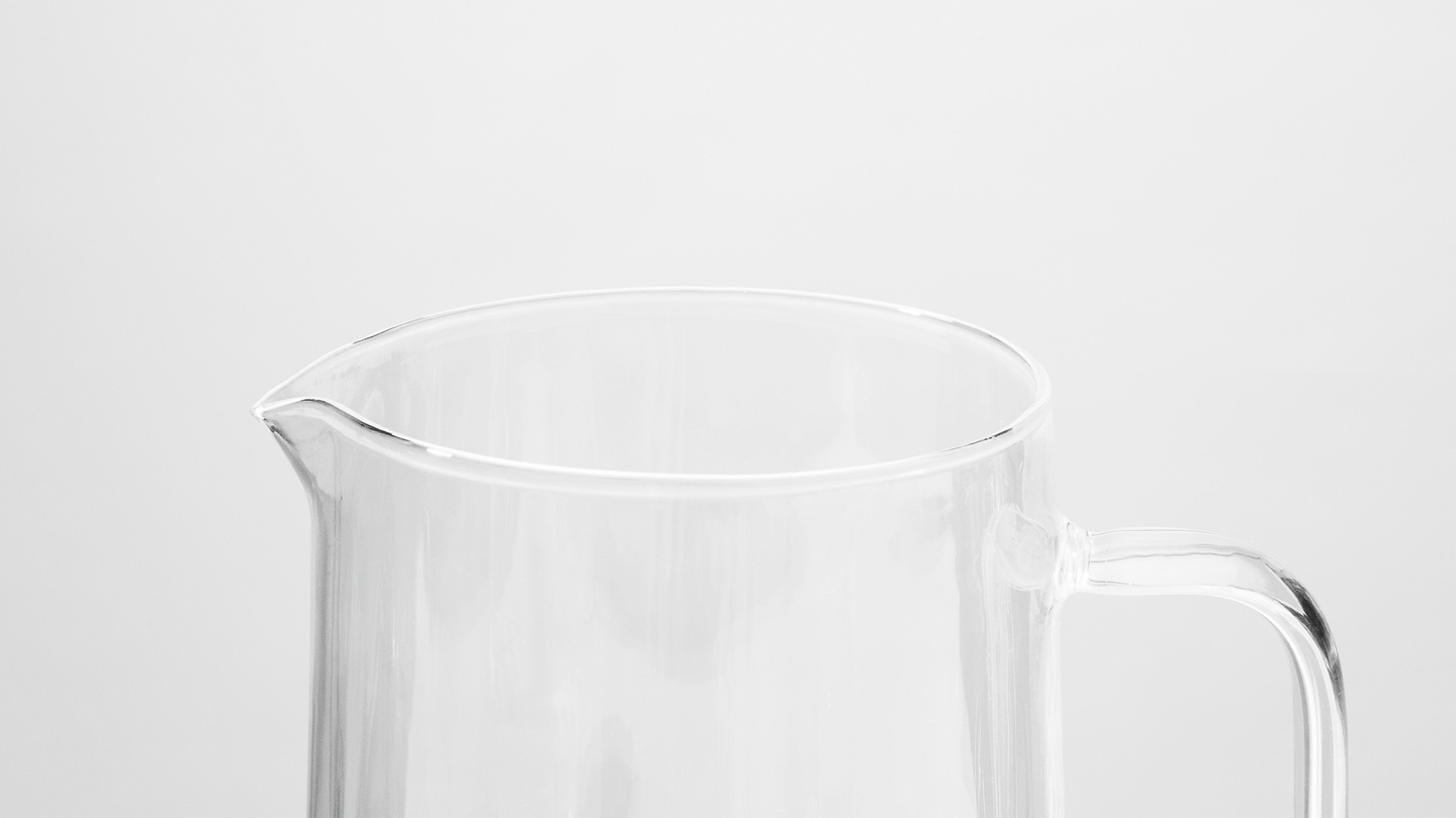 Close-up of the spout and handle of a clear glass pitcher