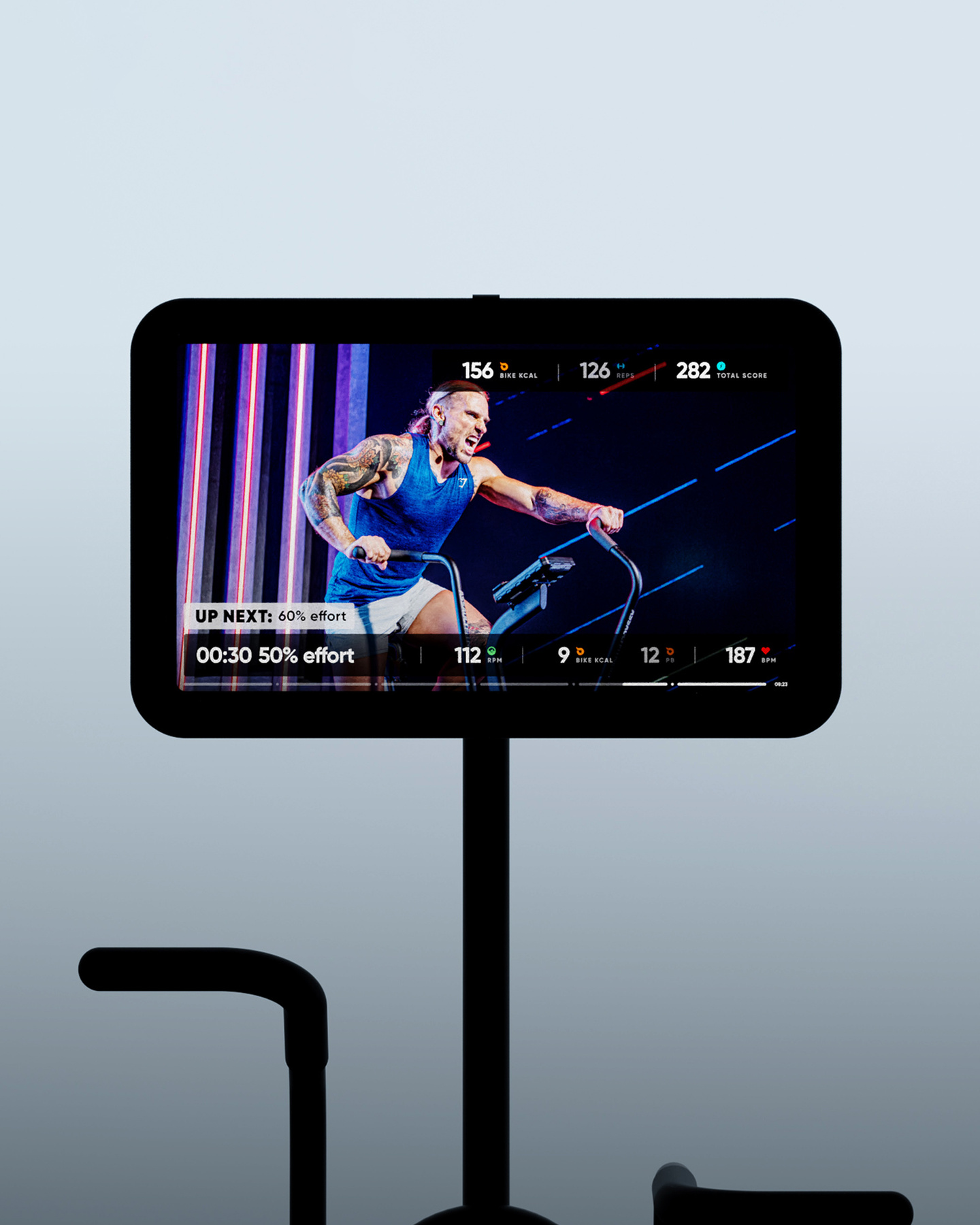 Black fitness stand structure with a screen display unit mounted on top against a dark gradient background