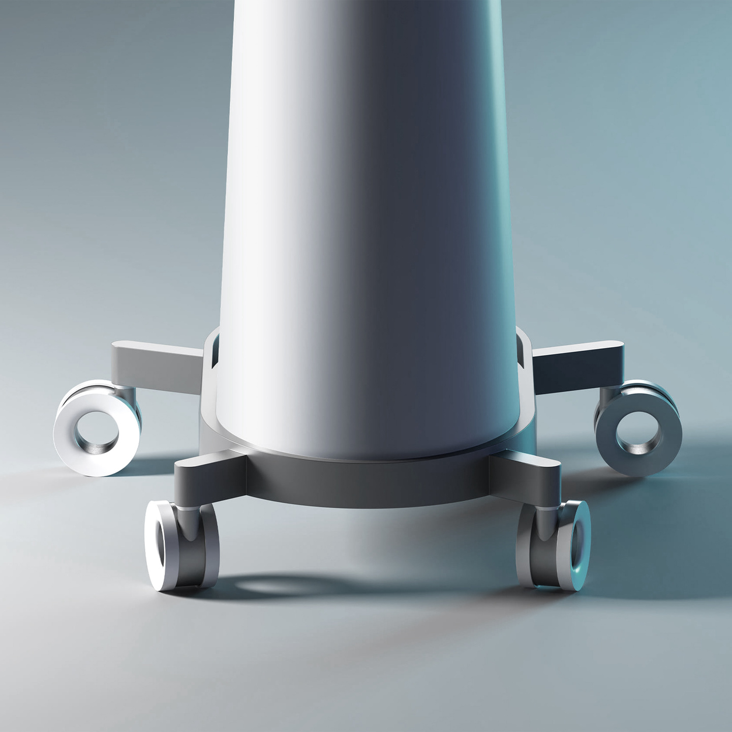 Lower section of a grey medical device showing castor wheels resting on a plain floor