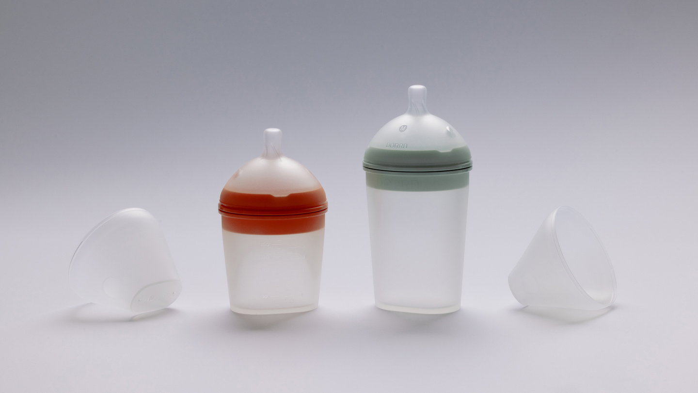 Two BORRN silicone baby feeding bottles shown side-by-side on a light grey background.