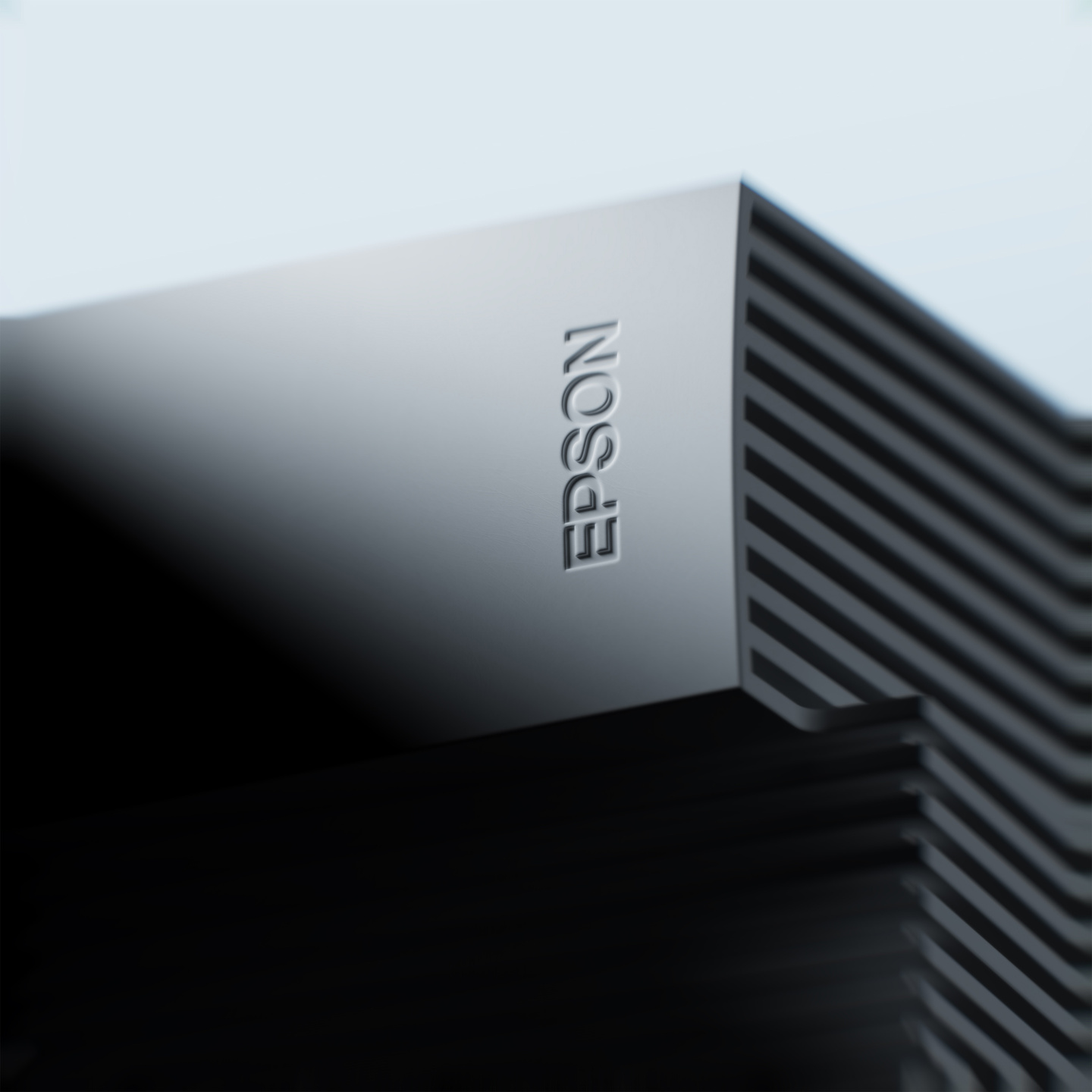 Close-up view of debossed Epson logo on ribbed dark projector casing
