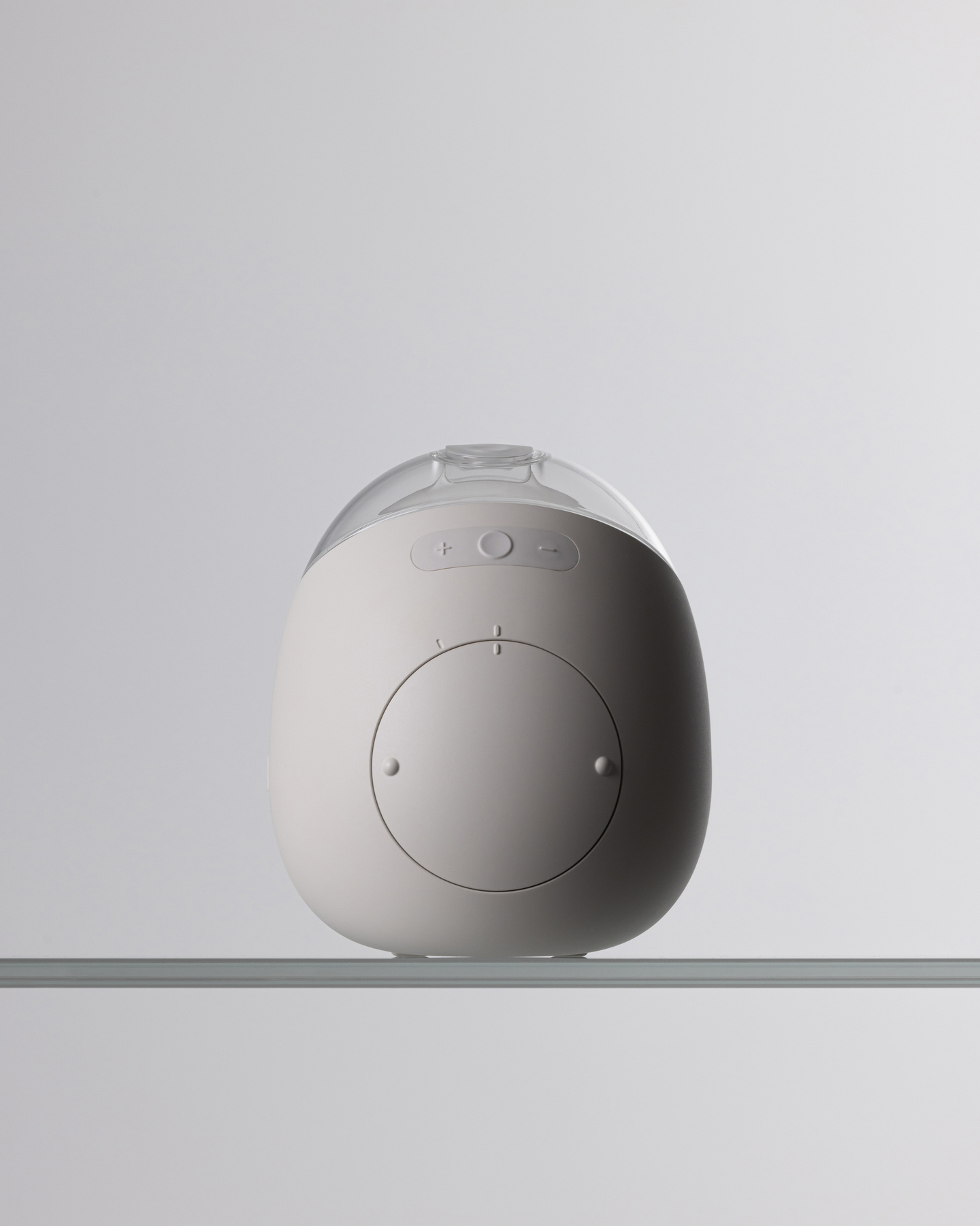 Front profile view of the white Avira breast pump resting on a surface.
