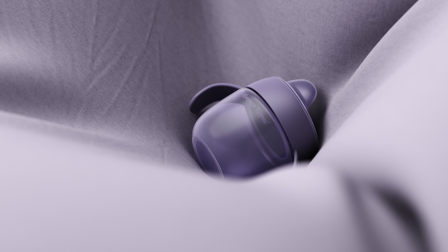 Close-up of a purple plastic cap resting on draped purple fabric