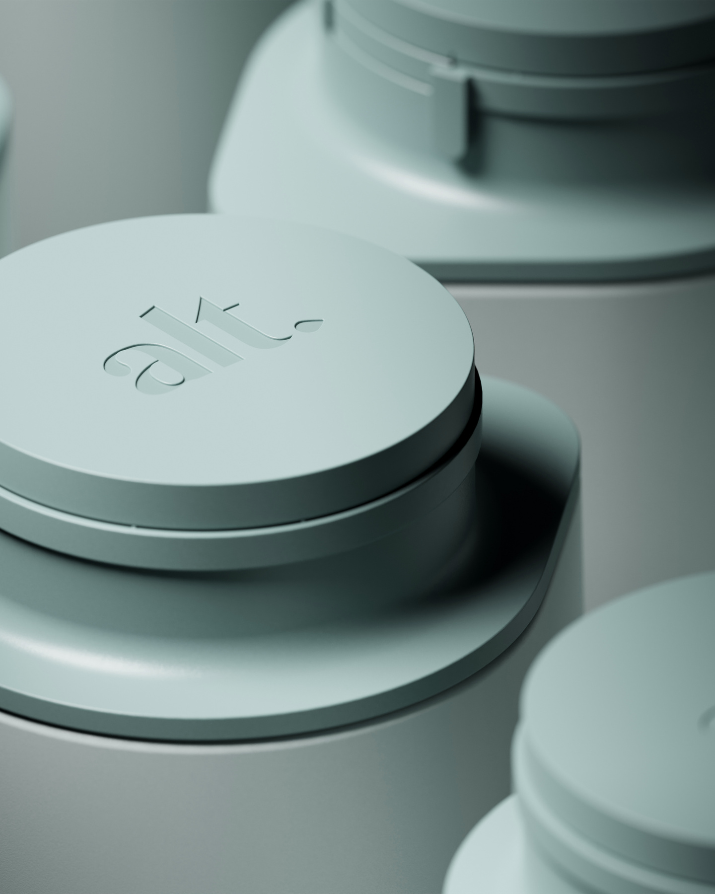 Close-up view of a circular grey cap debossed with the alt logo