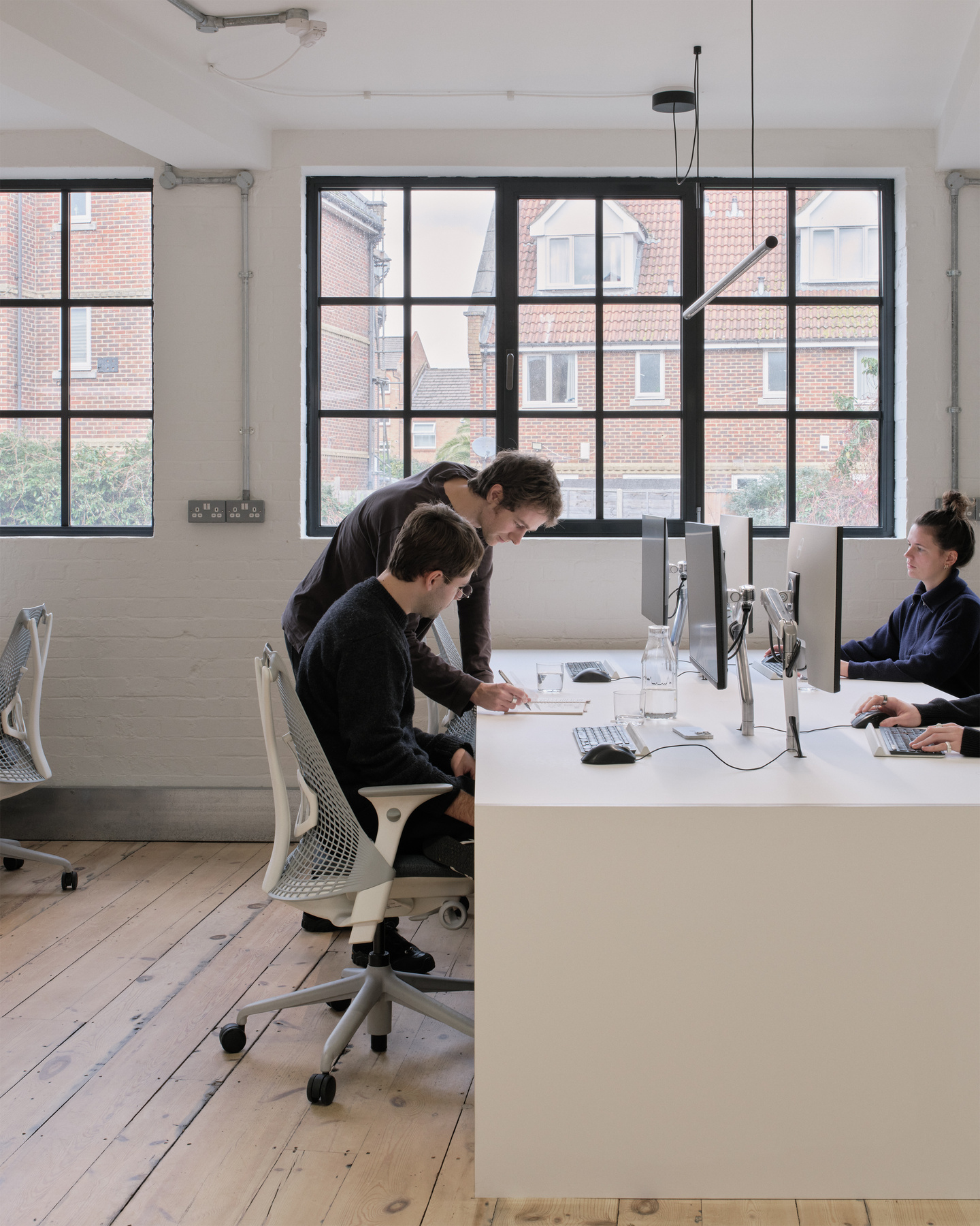 Photograph of the BLOND workspace with some of its designers collaborating.