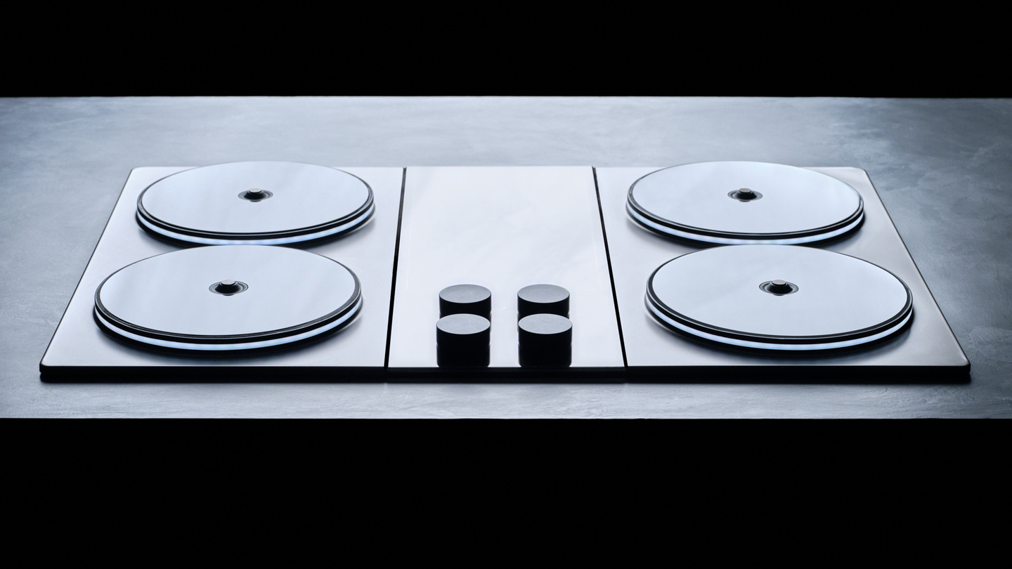 3D render of an induction stovetop with four burners and central control panel