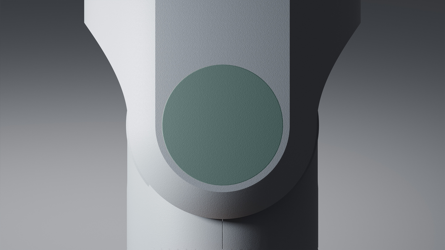 Close-up view of a matte grey component joint featuring a circular central element.