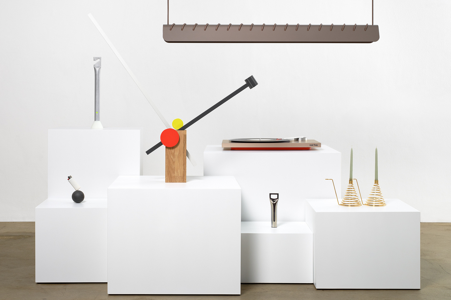 White display plinths showcasing prototype objects in gallery space