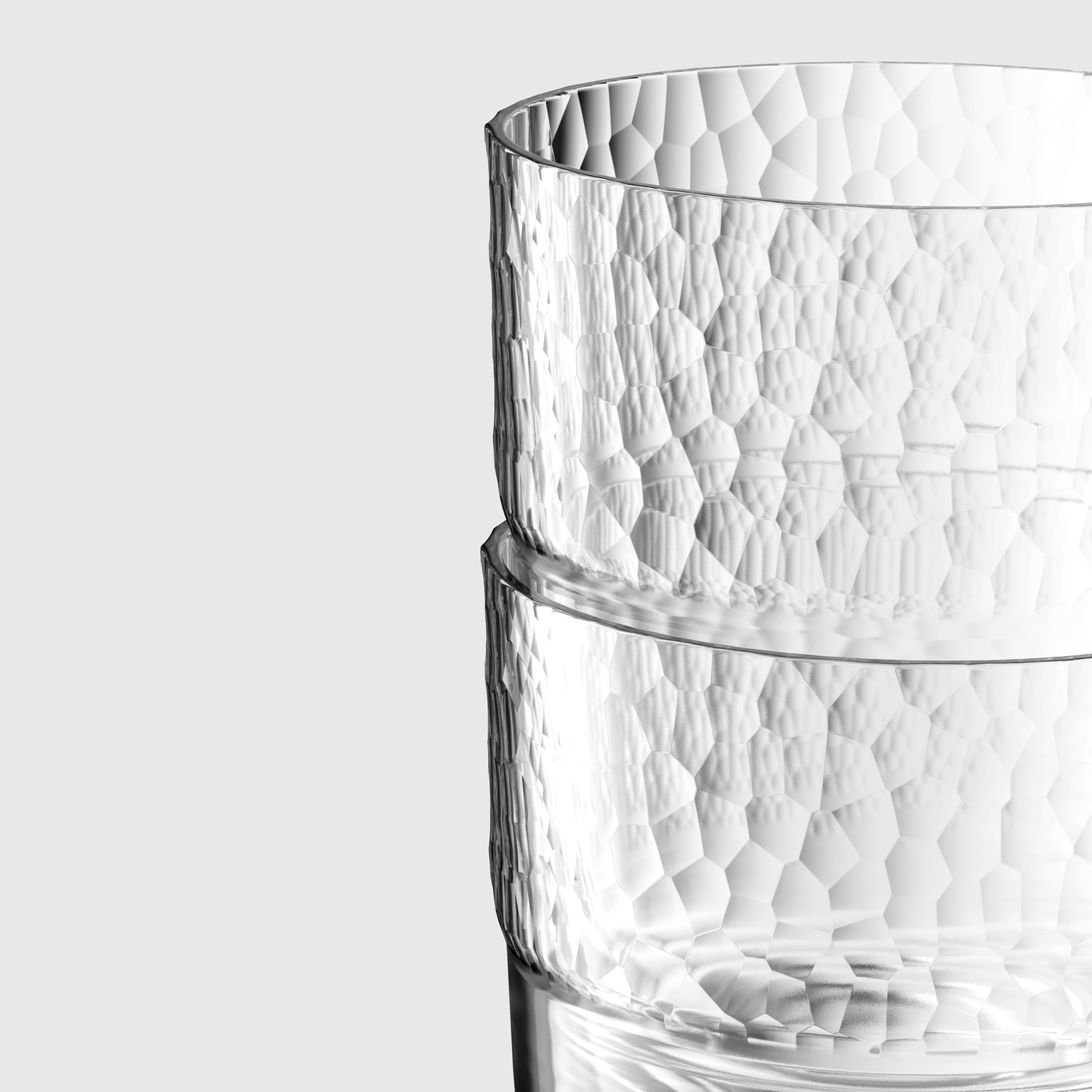 Stacked clear glass cups featuring a hammered textured surface pattern.