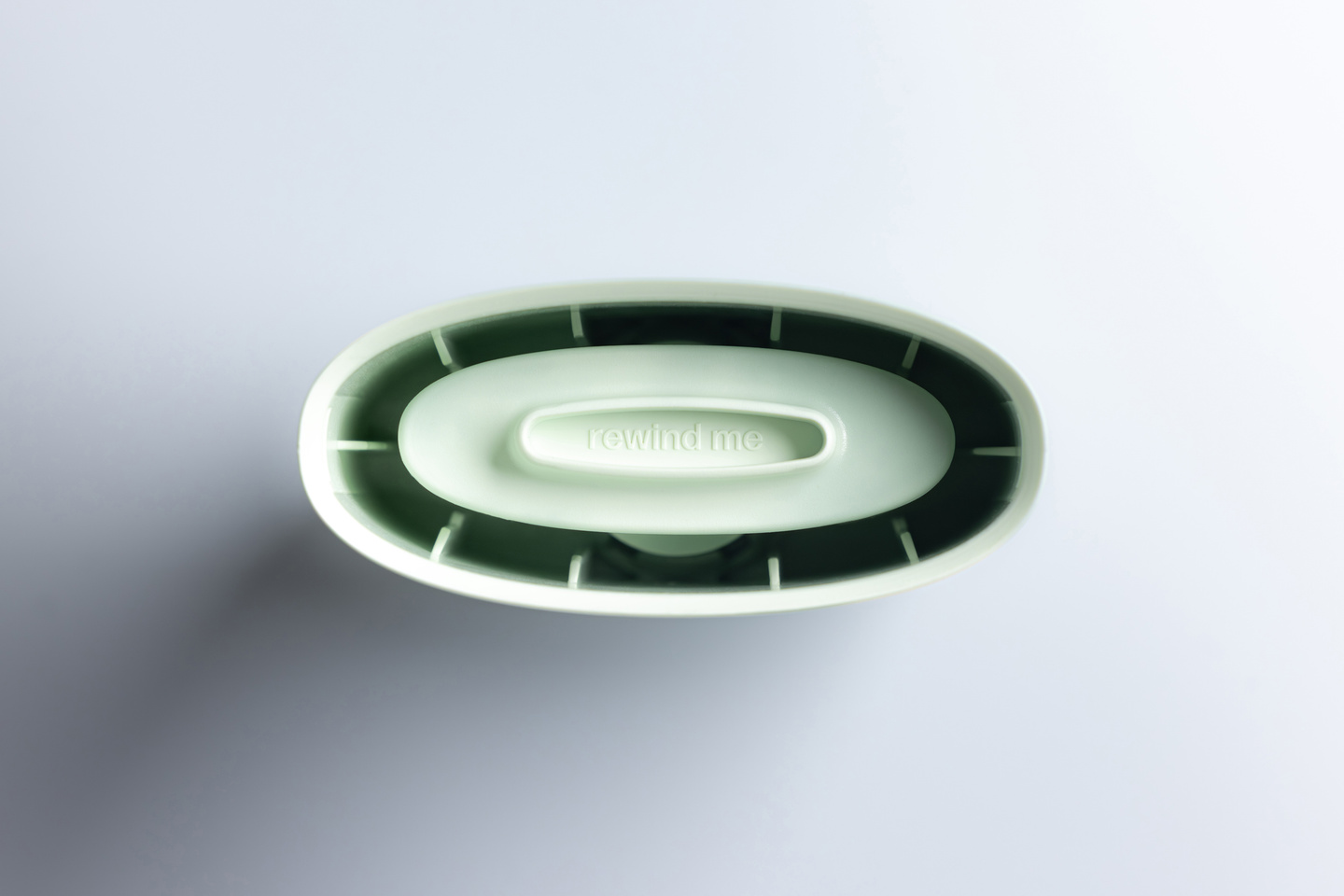 Top-down view into an open mint green Fussy deodorant case shell.