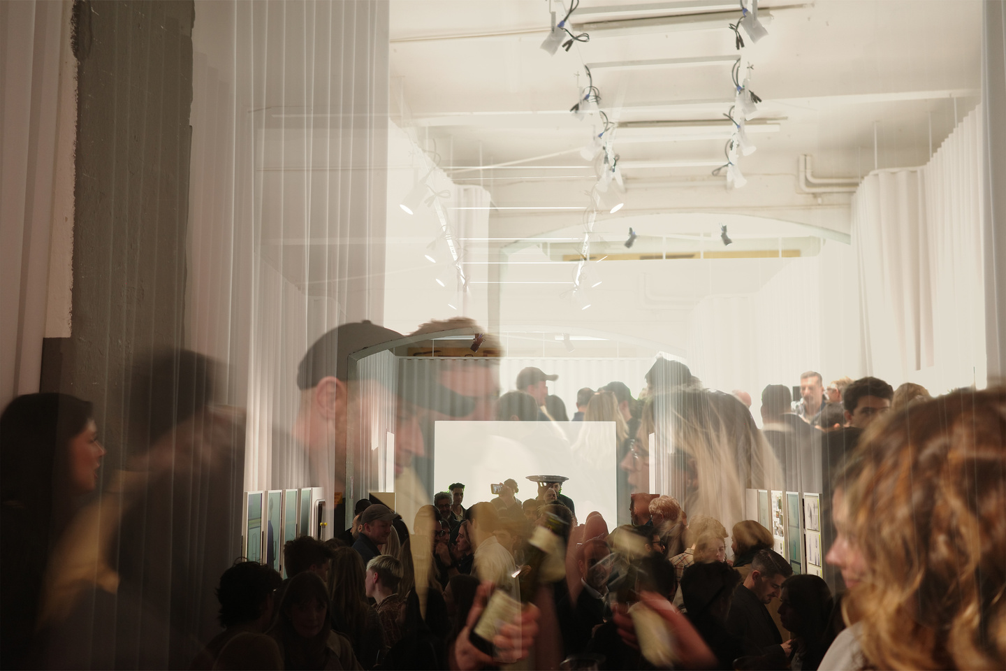 Guests filling main exhibition room during Milan Design Week showcase