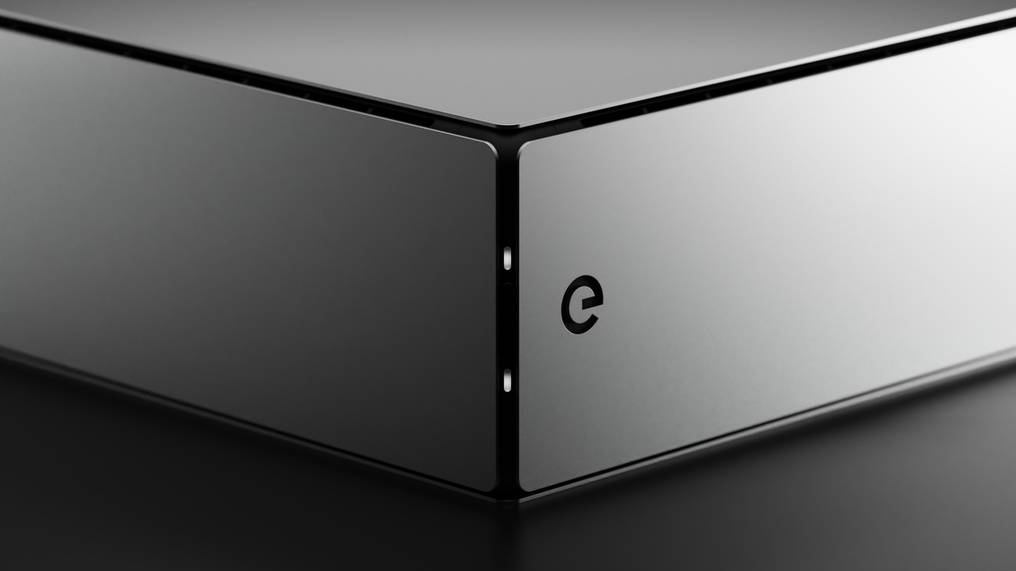 Corner detail render of dark grey metallic electronic hardware enclosure on dark backdrop
