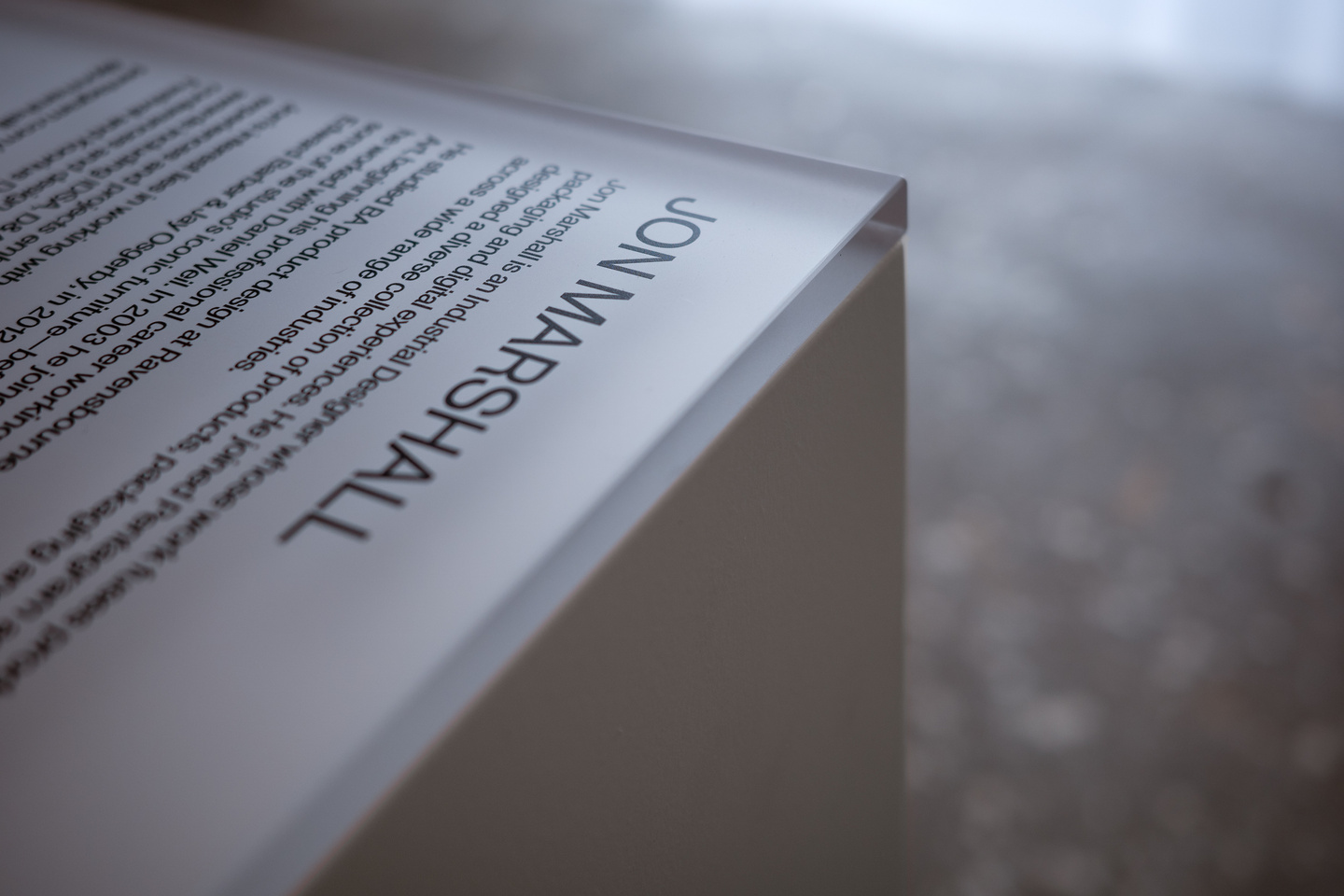 Close-up view of printed text graphics on white plinth surface